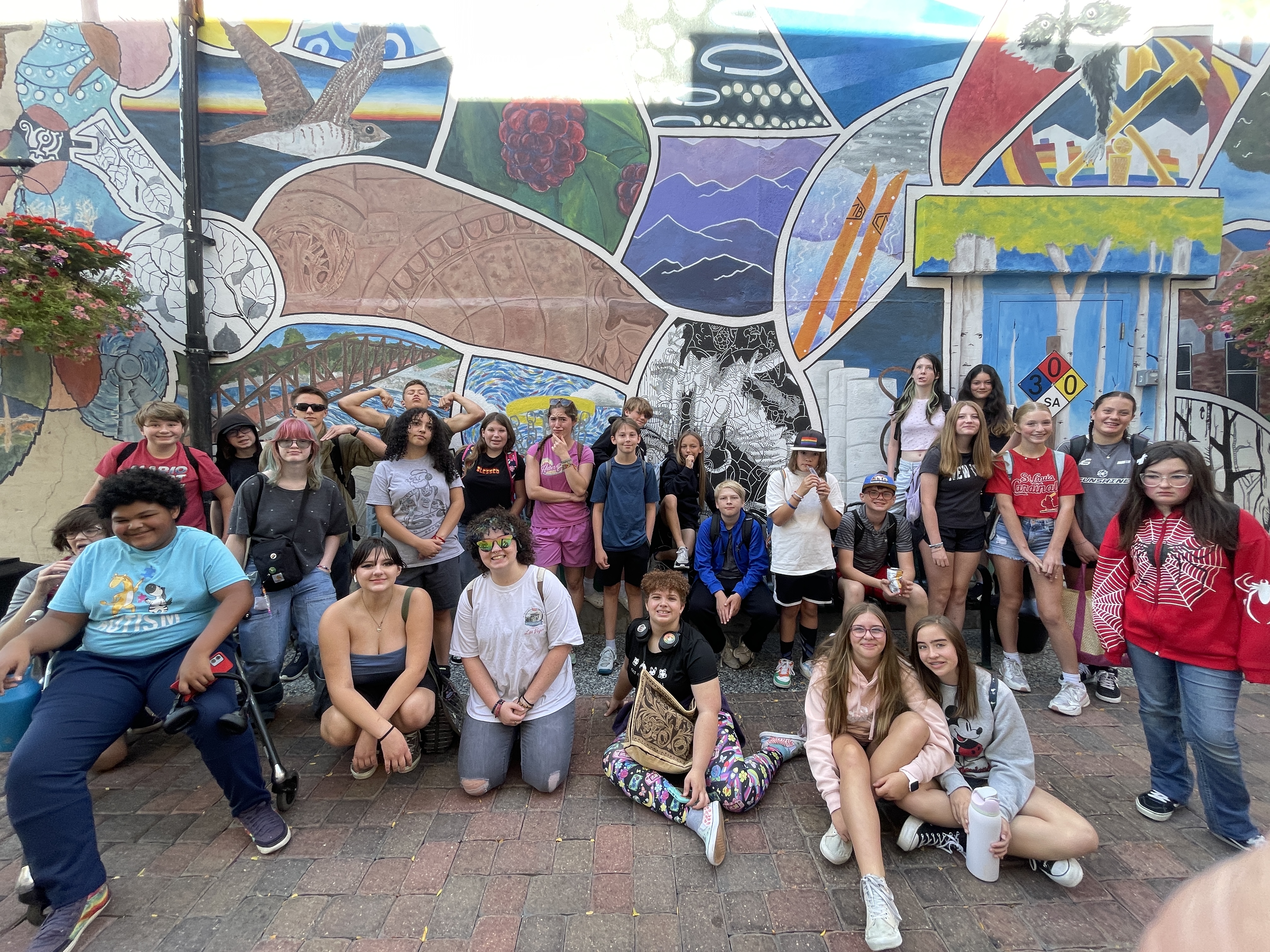 Students in the "Fun in the Fort" intensive posing in front of an old town mural.