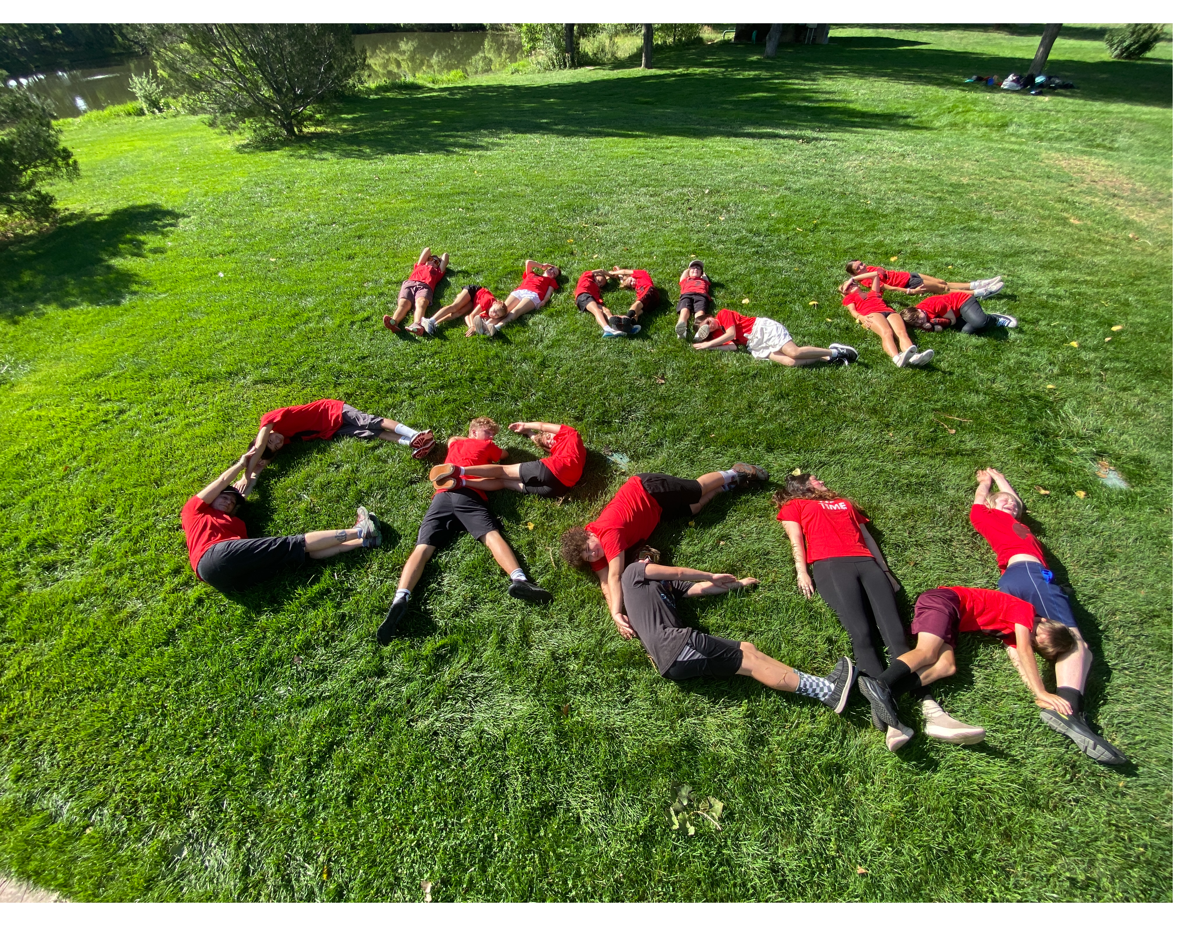 Mikoles Crew Laying on the Ground to spell out "Wolf Crew"